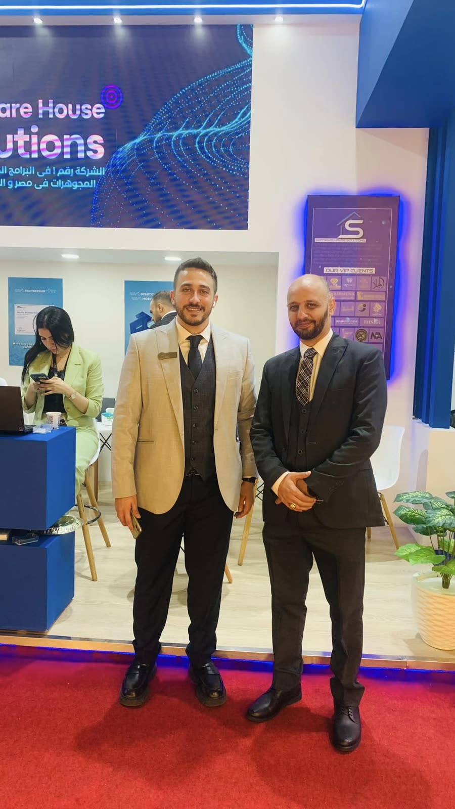 Two Software House Solutions team members at the company stand during NEBU Expo 2023.