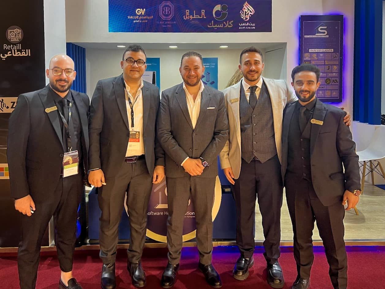 Five members of the SWH team in front of the client display at NEBU Expo 2024.