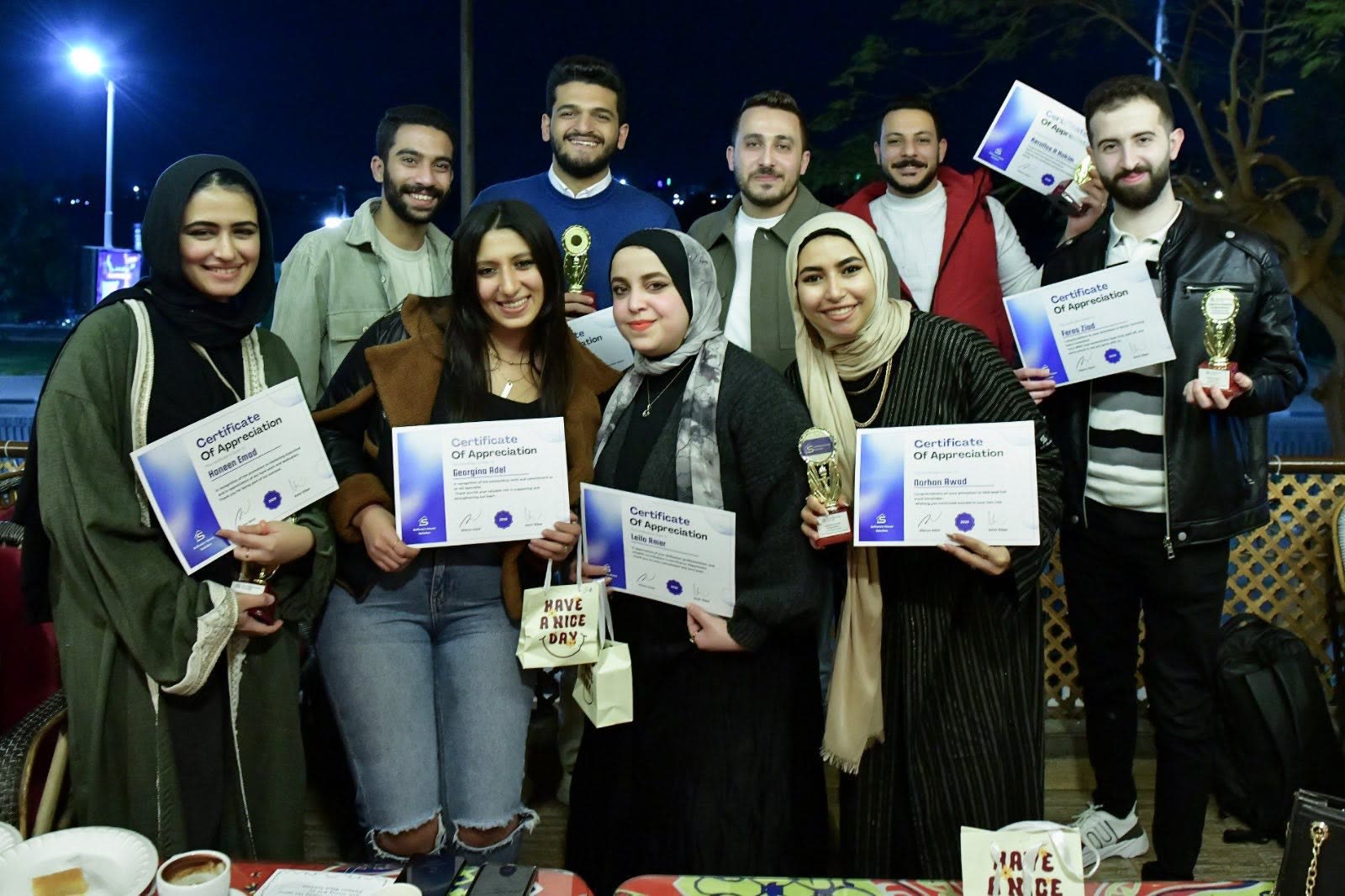 Colleagues holding their certificates of appreciation at the Ramadan outing.